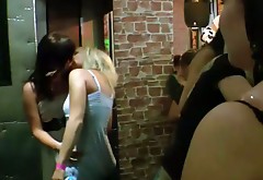 Sassy bitches are kissing passionately in a club