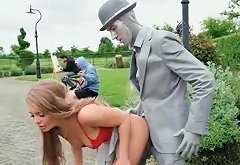 Busty chick fucks a living statue performer outdoors
