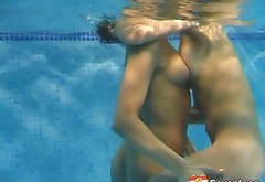 Sweet babes with nice tits having a passionate lesbian sex in the pool