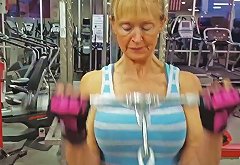 Old Woman with Large Breasts and Muscular Arms Trains Biceps 2