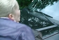 Frisky blond slut demonstrates her twat while standing on car hood in doggy style