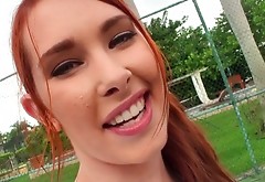 Charming red haired chic gives her head outdoor