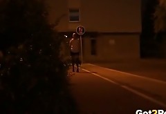 Big assed blond chick pees at the street in the darkness