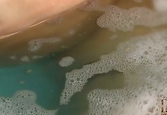 Curvy brunette goddess masturbates right in the hot bath for orgasm
