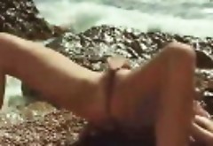 Nadina L spreads legs and masturbates by the sea