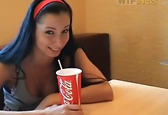 Cheesy amateur girl is having coke in cafe