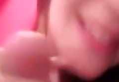 Cute brunette girlie in pink jacket happily sucks fat cock on camera