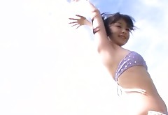 Upset nympho Nana Akiyama wanders along the beach showing her ass