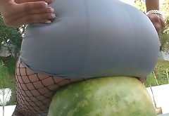 Charming brunette babe smashes watermelon with juicy ass