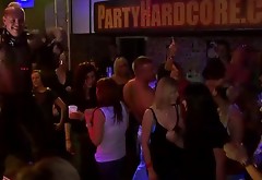 Naked girl in a club are pleasuring one another in public
