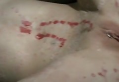 Naked brunette slave pounded with sex toy and covered in hot wax
