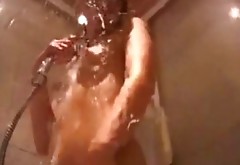 Flat as field brunette stimulates her shaved pussy with hot water stream