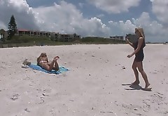 A perfectly shaped blonde shows her boobs on a beach