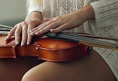 Libidinous babe playing violin and masturbating her pussy