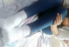 Chinese Girl Massages her Foot in White Sport Socks