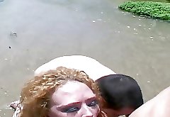 Nasty whore Audrey gets fucked by two guys in a lake