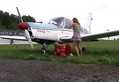 Seductive busty amateur lies on airplane wing while getting fucked in missionary pose