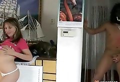 A young girl is standing in the living room, playing with a pink dildo. She rubs it over her tits when a naked guy in a mask appears behind her. Het w