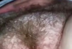 Rubbing and fingering a hairy mature vagina