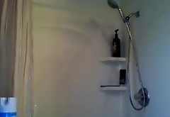 MILF plays with showerhead while standing
