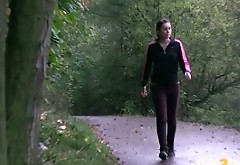 Shy dark haired wench in sports suit pees in woods